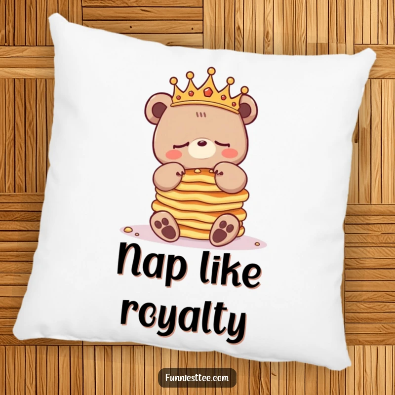Funny sleepy bear pillow with a crowned bear character balancing pancakes, offering plush comfort and a humorous visual for relaxation.