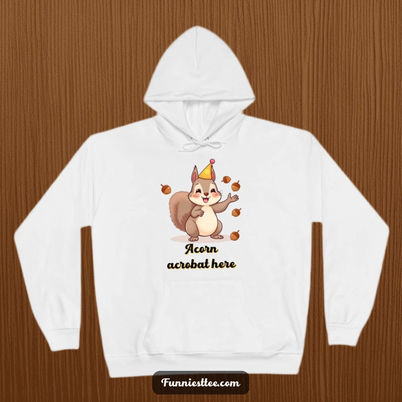 Funny hoodie featuring a cheerful squirrel in a party hat juggling acorns with energetic paws, radiating festive fun and playful chaos.