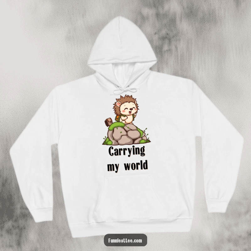 Funny hoodie featuring a tiny hedgehog with a backpack, excitedly climbing a mossy rock, offering cozy adventure.