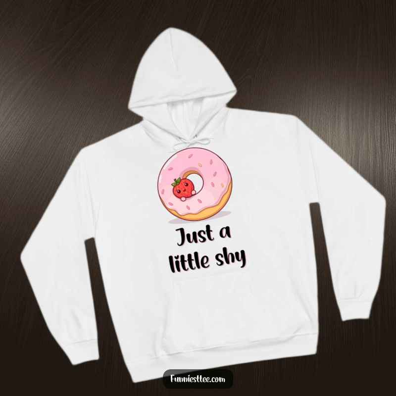 Funny Hoodie design: a small, shy strawberry peeks out from behind a large, laughing donut with colorful frosting.