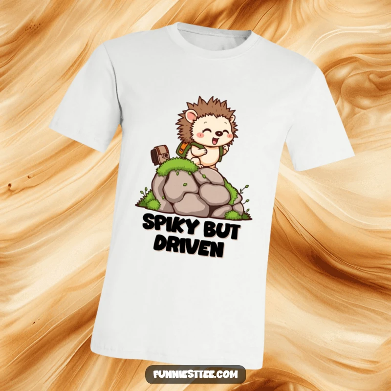 Funny t-shirt with a tiny hedgehog wearing a backpack, excitedly climbing a mossy rock, embodying determination.