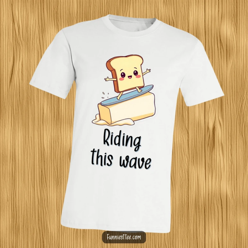 Funny t-shirt showing a determined toast character surfing a massive pat of butter, depicting a comical and adventurous breakfast scene.