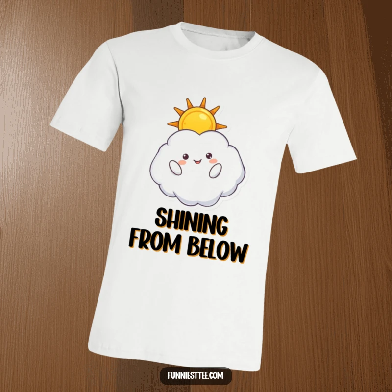 Funny t-shirt showing a fluffy cloud character upside down, cheerfully holding a bright sun, celebrating a topsy-turvy celestial scene.